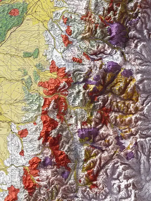 Technical soil map detail of a mountainous Chilean region with a topographic grid. The left side shows a flat yellow agricultural plain, while the rugged, high-altitude Andean slopes on the right are categorized by a thematic layout of bright red, purple and brown shapes defining soil composition